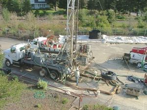 Drill rig and service truck for boring and grouting of vertical pipe loops