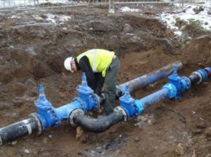 An underground water main is tapped with a separate valve
